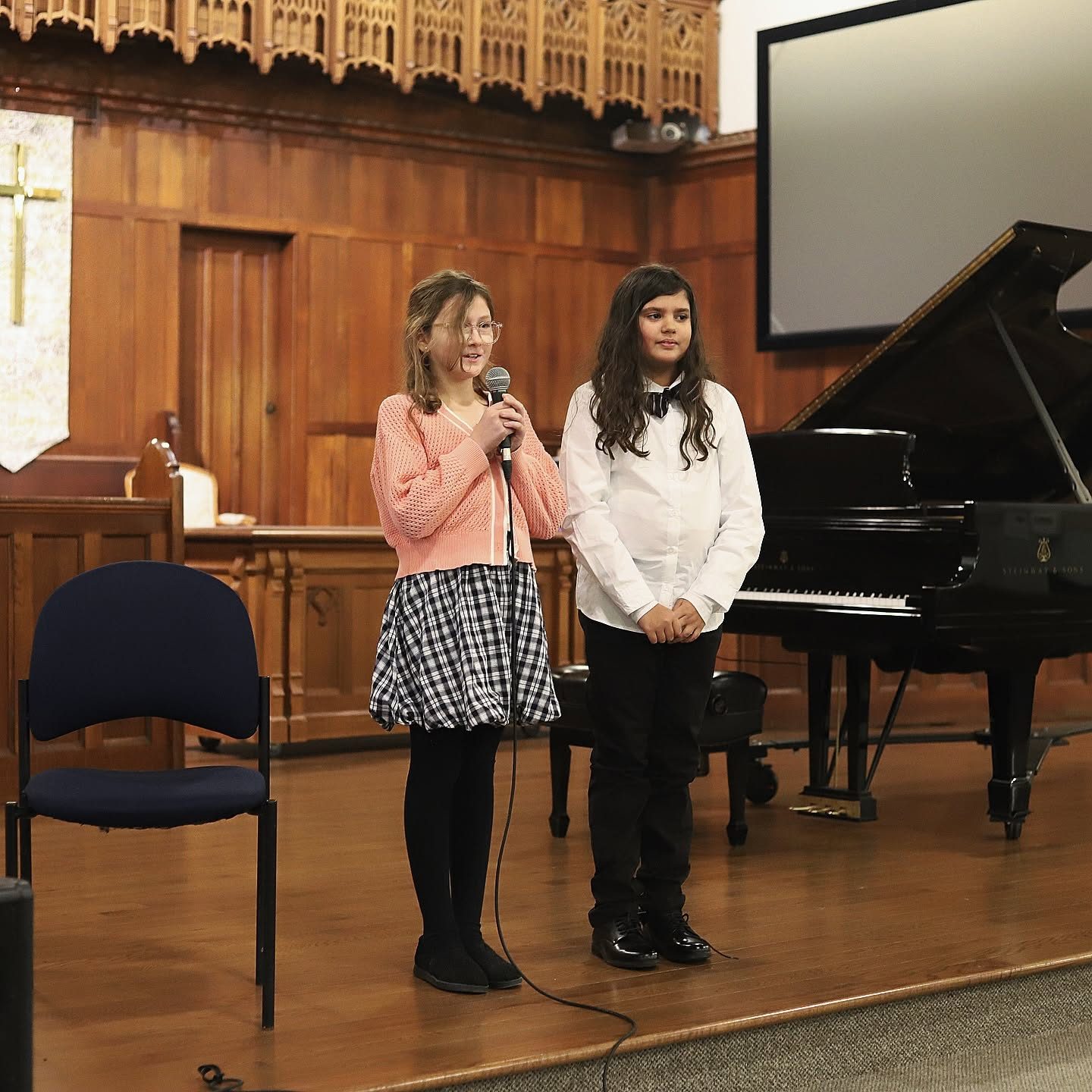Two young students introducing their recital performance