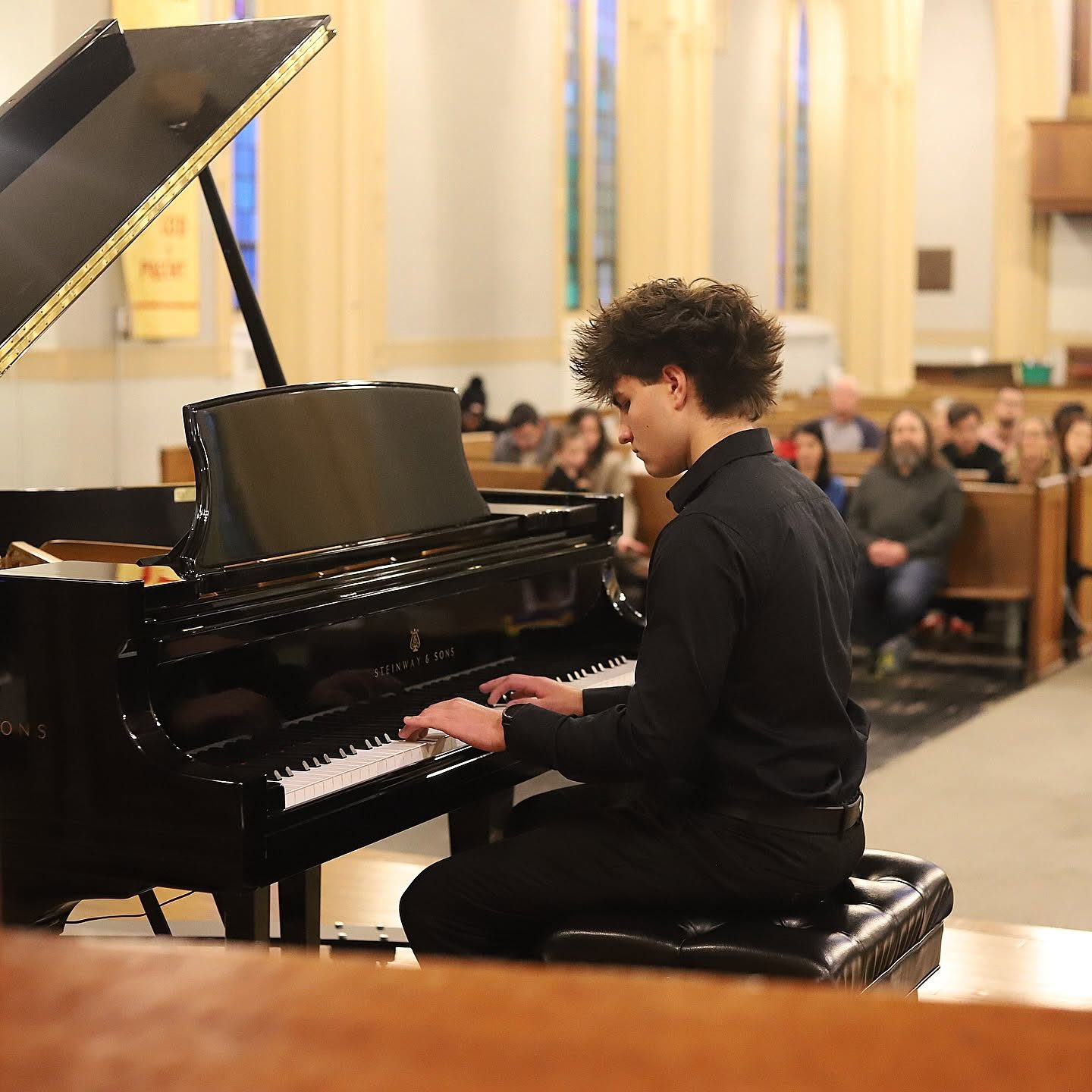 Advanced student performing on a Steinway grand