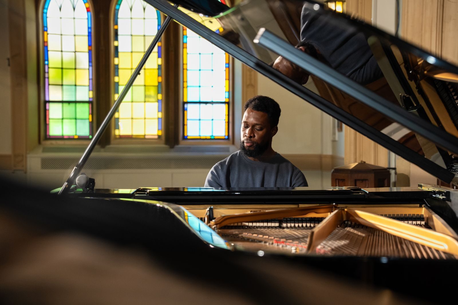 Adult pianist playing a grand piano